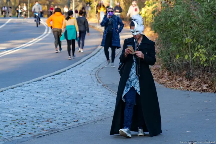 A photo of a person in a mask walking through Central Park